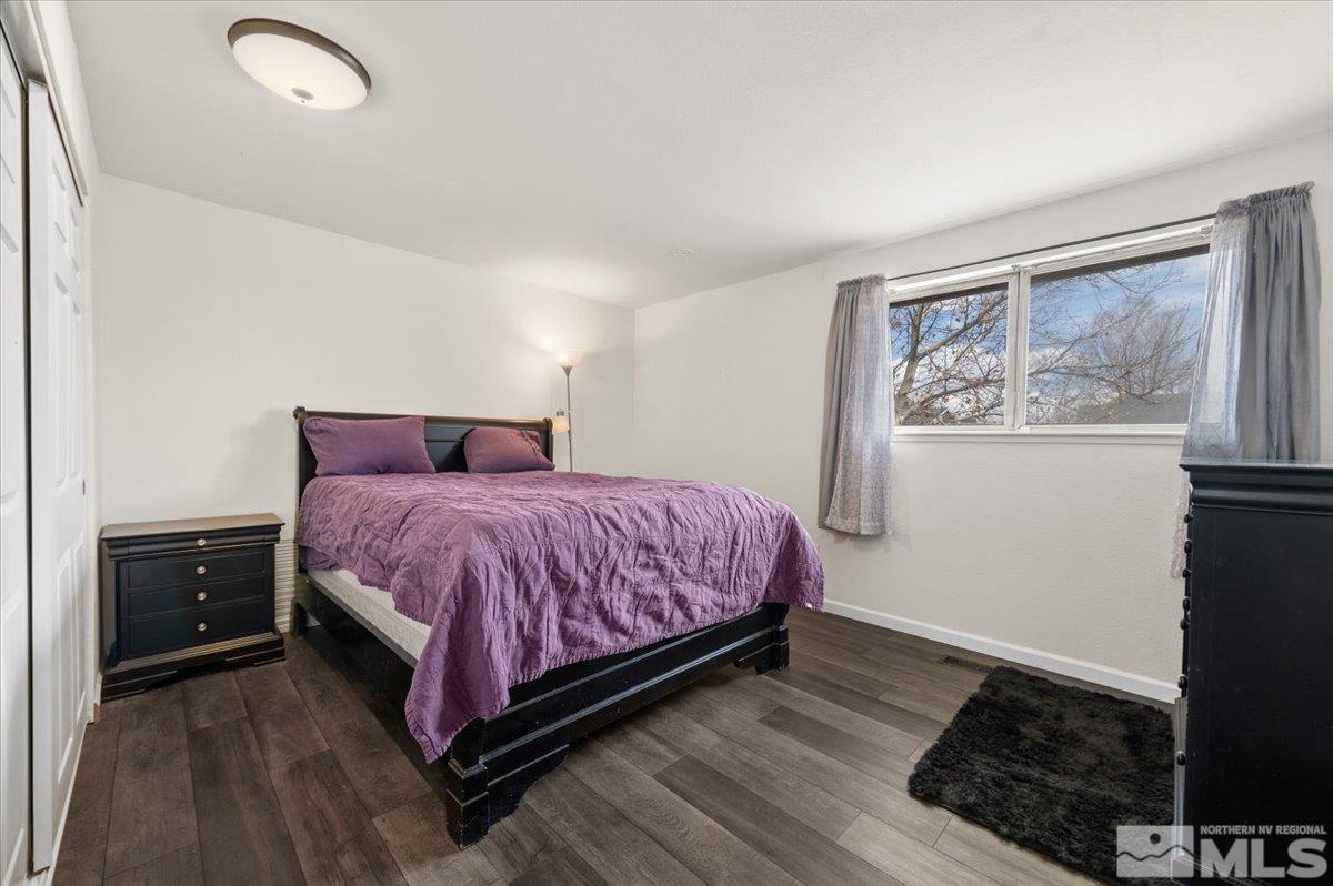 350 Sycamore Street Fernley, NV 89408 - Photo 12 of 24 a bedroom with a bed and wooden floor