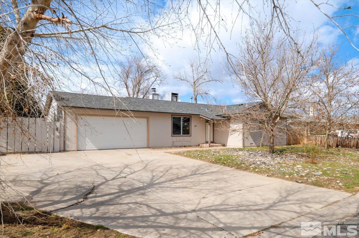 350 Sycamore Street Fernley, NV 89408 - Photo 2 of 24 a front view of a house with a yard and garage