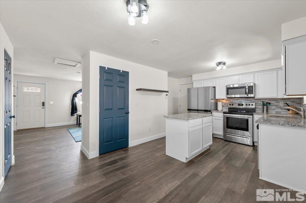 350 Sycamore Street Fernley, NV 89408 - Photo 6 of 24 a kitchen with white cabinets and stainless steel appliances