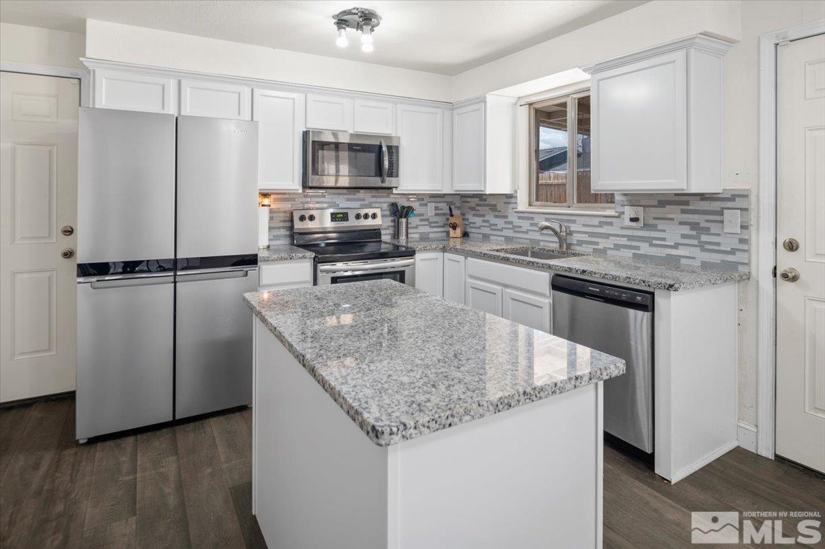 350 Sycamore Street Fernley, NV 89408 - Photo 7 of 24 a kitchen with stainless steel appliances granite countertop a sink stove and refrigerator
