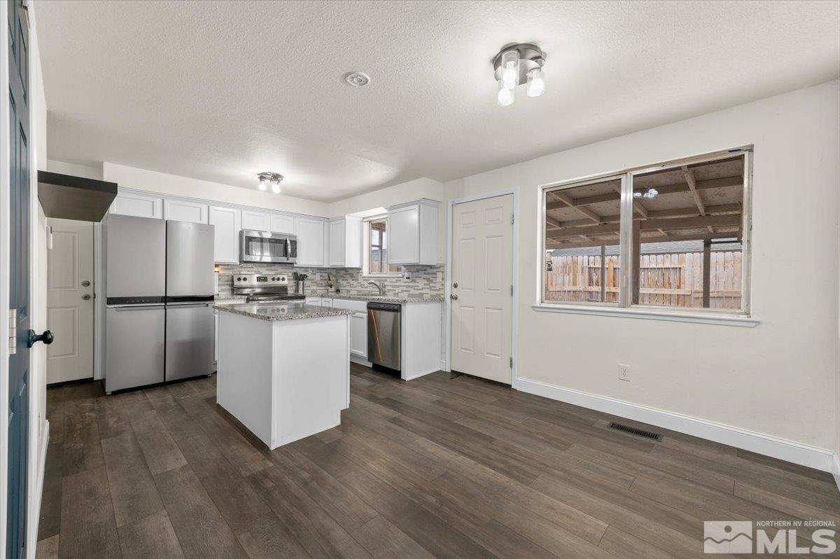 350 Sycamore Street Fernley, NV 89408 - Photo 10 of 24 a kitchen with white cabinets and white appliances