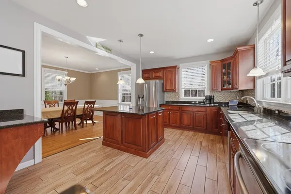 a kitchen with lots of counter top space a sink appliances and cabinets