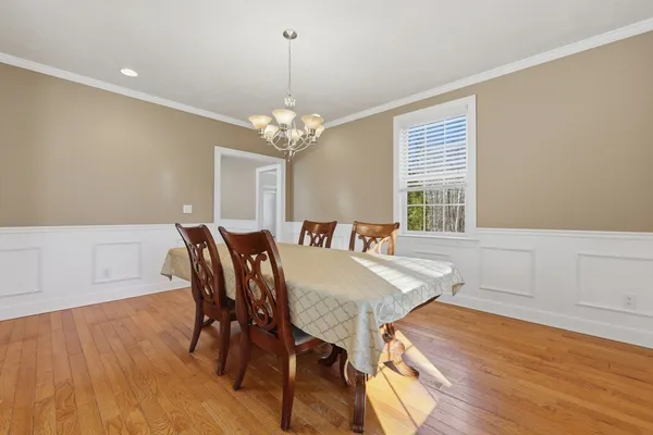 a view of a dining room with furniture wooden floor and chandelier