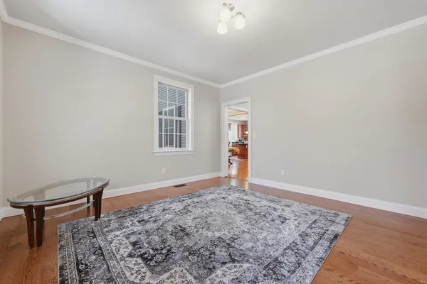 a view of a livingroom with wooden floor and a window