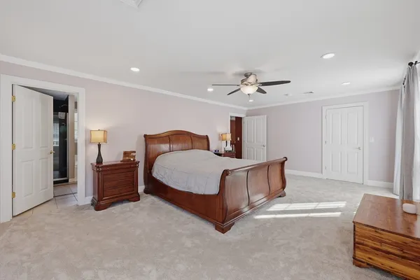 a spacious bedroom with a bed and a couch