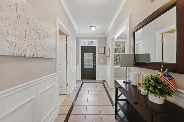 a hallway with dining table and chairs