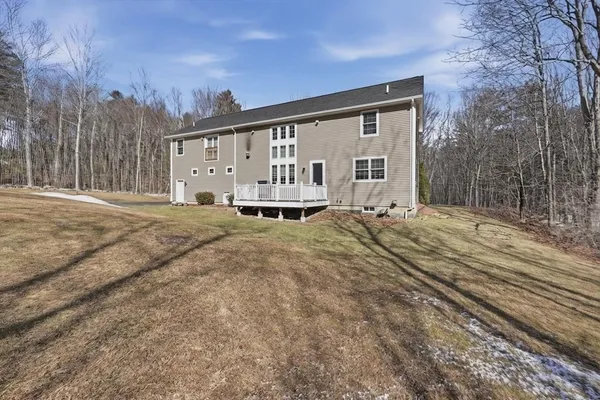 a front view of a house with a yard outdoor seating and garage