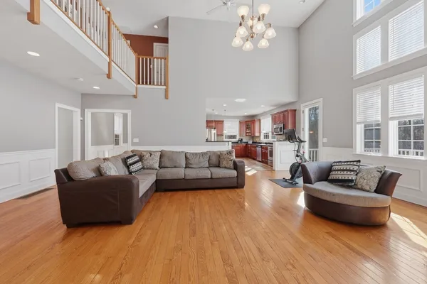 a living room with furniture wooden floor and a chandelier