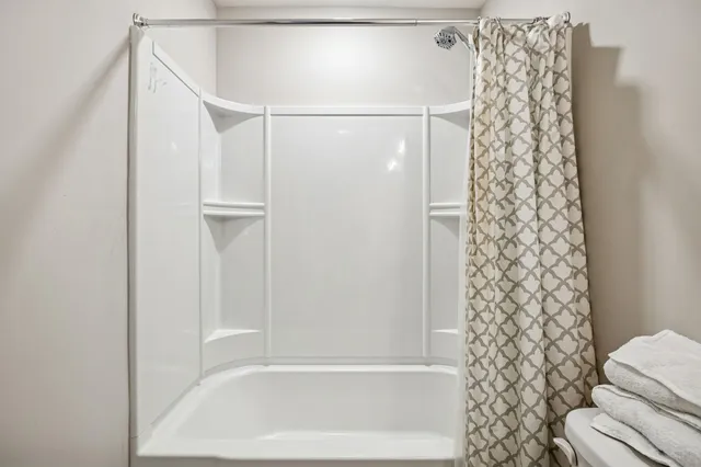 a bathroom with a bathtub and shower