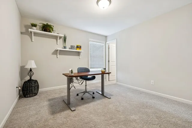 a workspace with furniture and window