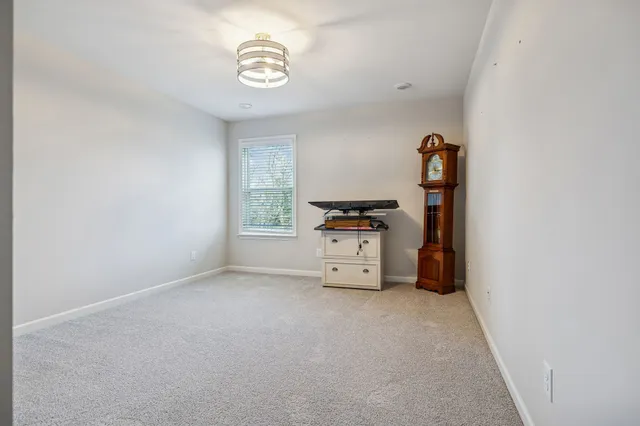 a view of kitchen with cabinets and window