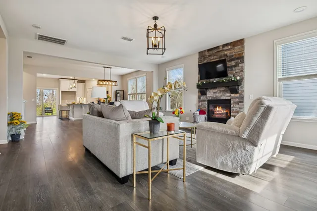 a living room with furniture a fireplace and a flat screen tv