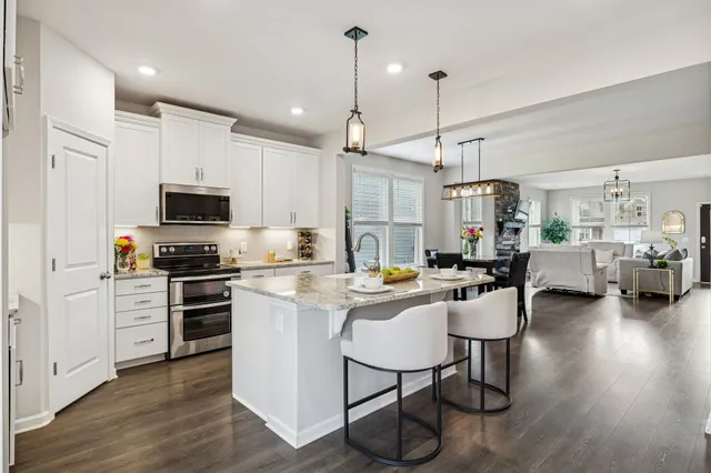 a kitchen with sink cabinets and wooden floor