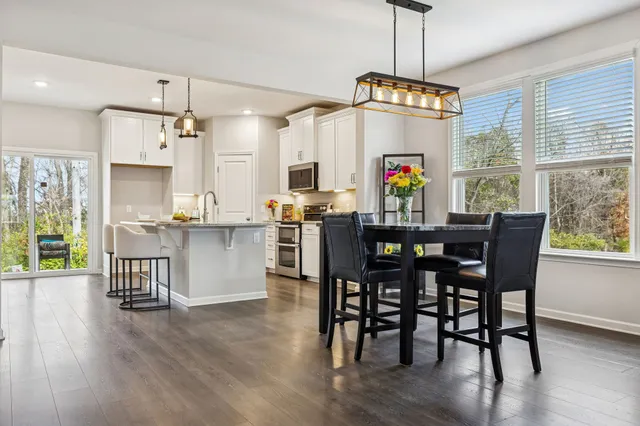 a view of a dining room with furniture window and wooden floor