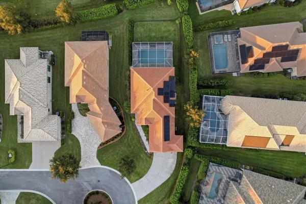 an aerial view of house with pool garden and outdoor seating