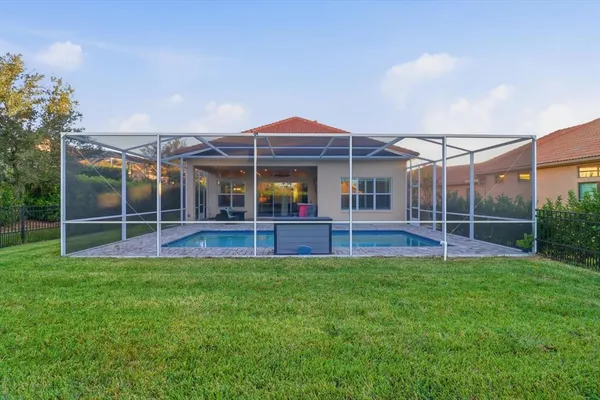 a view of an house with backyard and porch