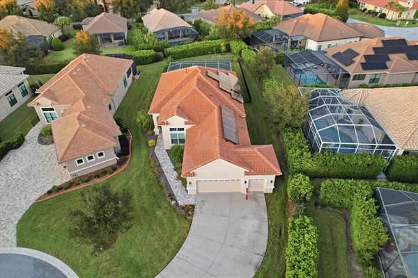 an aerial view of residential houses with outdoor space and street view