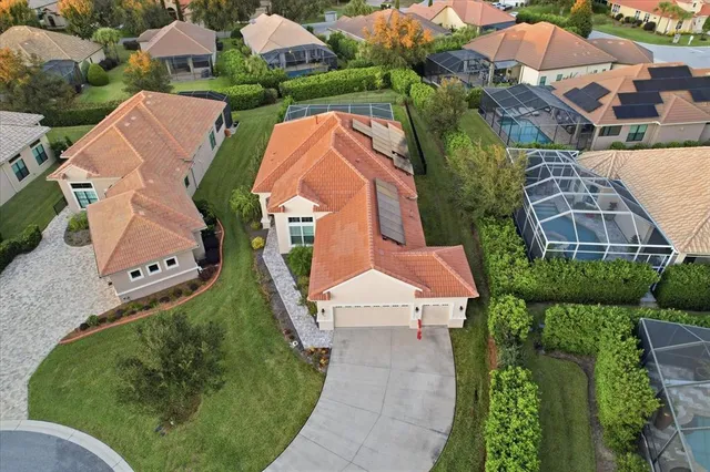 an aerial view of residential houses with outdoor space and street view
