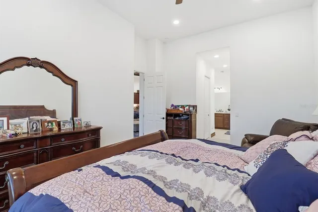 a bedroom with furniture and a large window