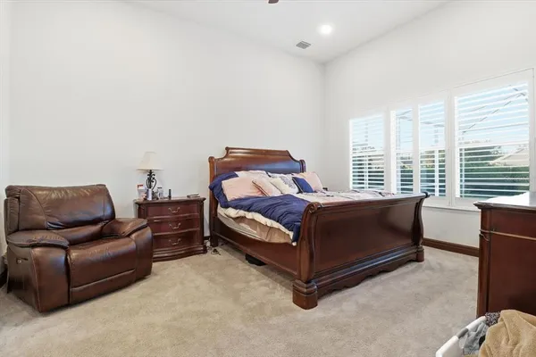 a bedroom with a bed and a desk