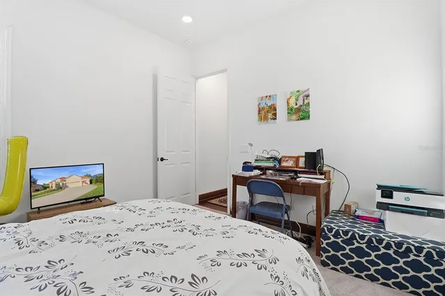 a bedroom with a bed a couch and a window