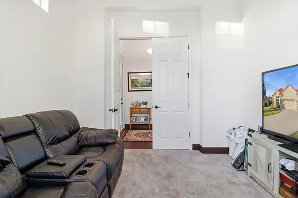 a front view of a house with wooden floor and a chandelier
