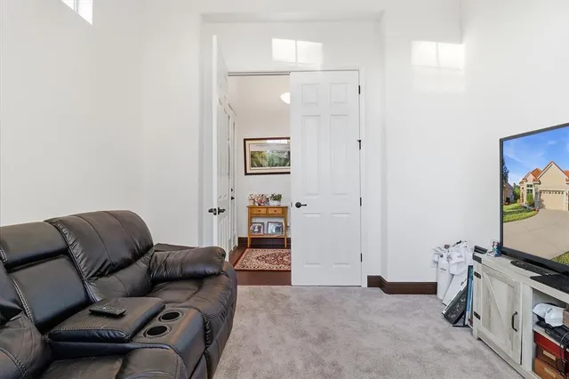 a front view of a house with wooden floor and a chandelier