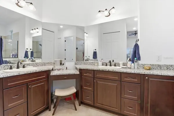 a bathroom with a granite countertop sink double and mirror