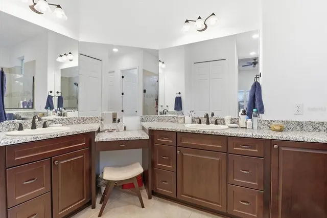 a bathroom with a granite countertop sink double and mirror