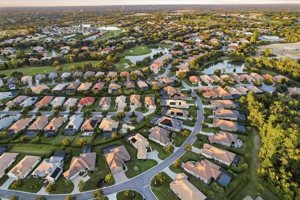 an aerial view of residential houses with outdoor space