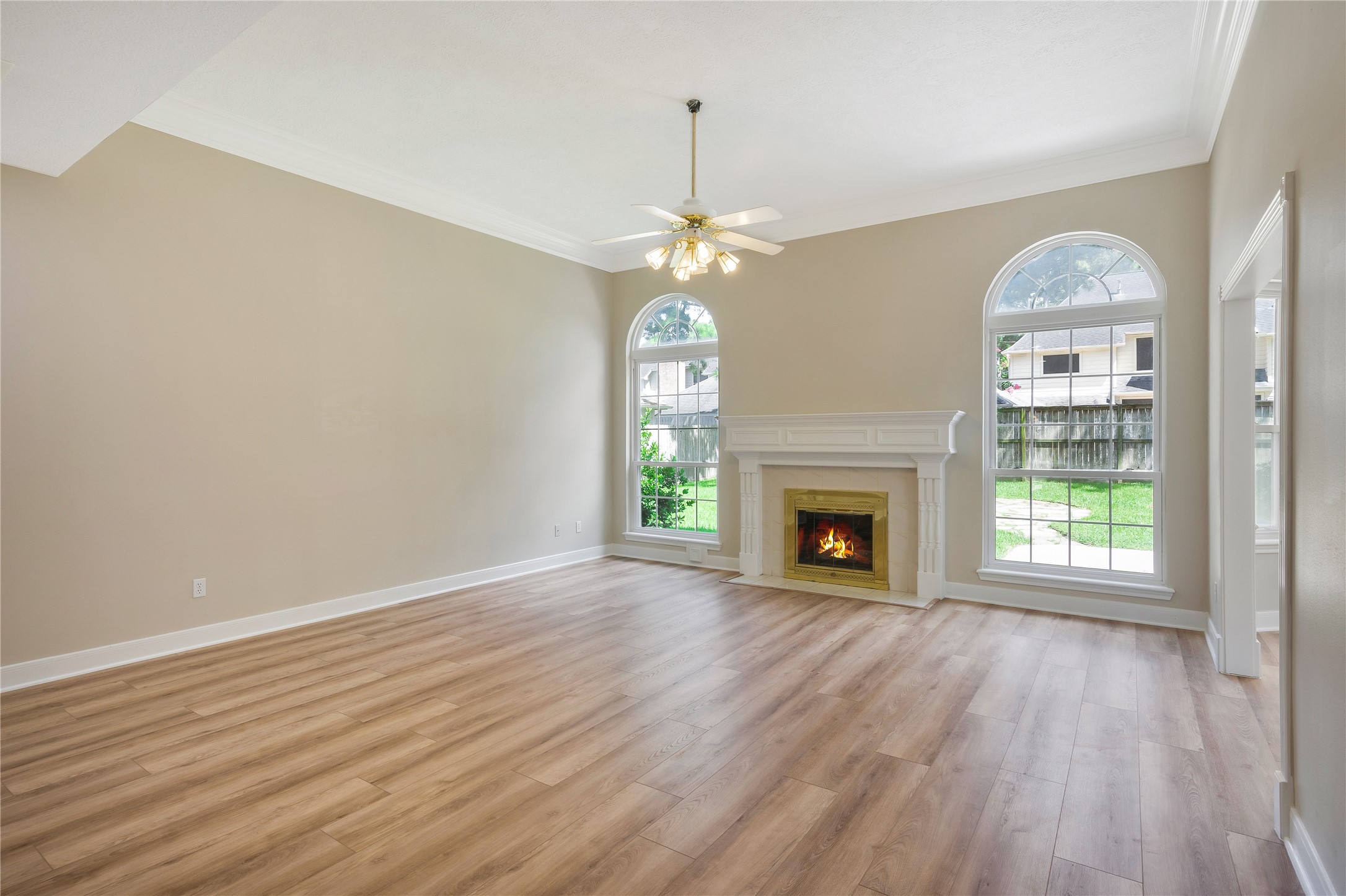 8011 Null Court Spring, TX 77379 - Photo 13 of 41 Large Living Room features gas fireplace and floor to ceiling windows.
