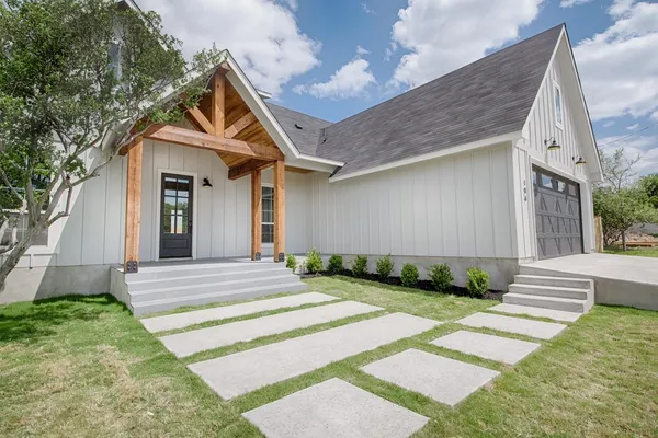 a front view of a house with garden
