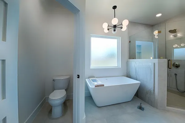 a white bath tub sitting next to a white toilet
