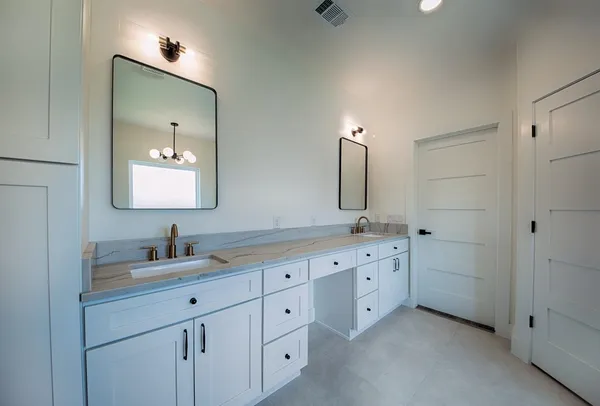 a bathroom with a double vanity sink and mirror with shower