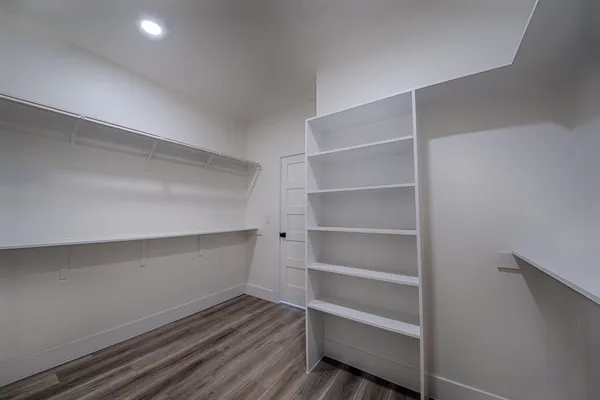 a view of walk in closet with empty racks