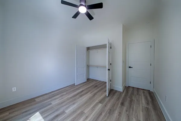 a view of a hallway with wooden floor