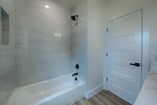 an empty room with wooden floor a ceiling fan and closet