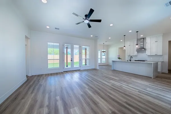 a view of kitchen and window with wooden floor