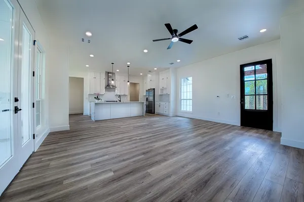 a view of a kitchen with a wooden floor and a kitchen