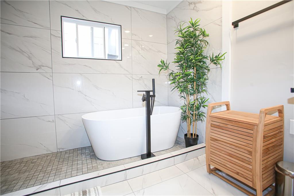 4830 Rebel Trail Sandy Springs, GA 30327 - Photo 14 of 75 a white bath tub sitting in a bathroom