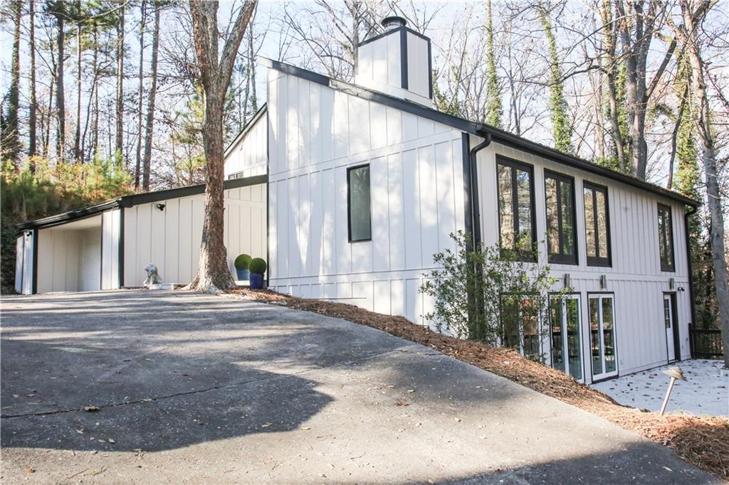 4830 Rebel Trail Sandy Springs, GA 30327 - Photo 3 of 75 a front view of a house with a yard and garage