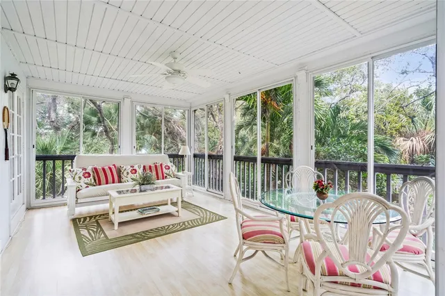 a living room filled with furniture and a floor to ceiling window