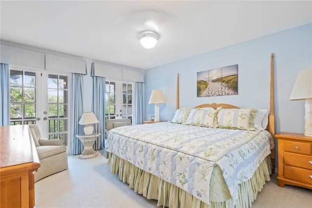 a bedroom with a large bed and a large window