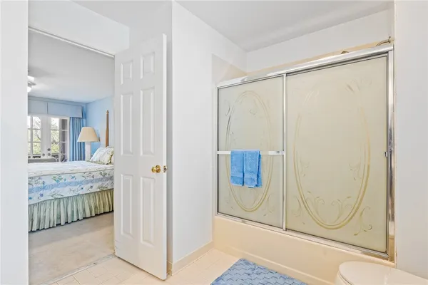 a bathroom with a granite countertop shower and mirror