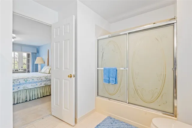a bathroom with a granite countertop shower and mirror