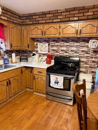 a kitchen with stainless steel appliances granite countertop a stove and cabinets