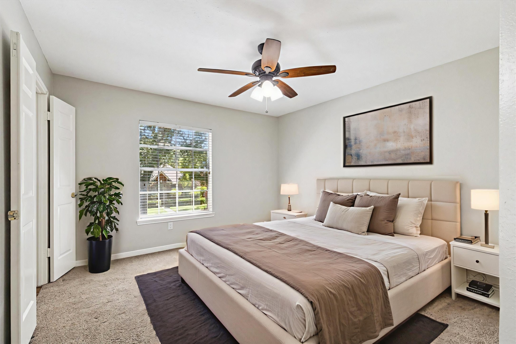 2006 Raven's Crest Drive Sugar Land, TX 77478 - Photo 18 of 29 a bedroom with a large bed and a chandelier