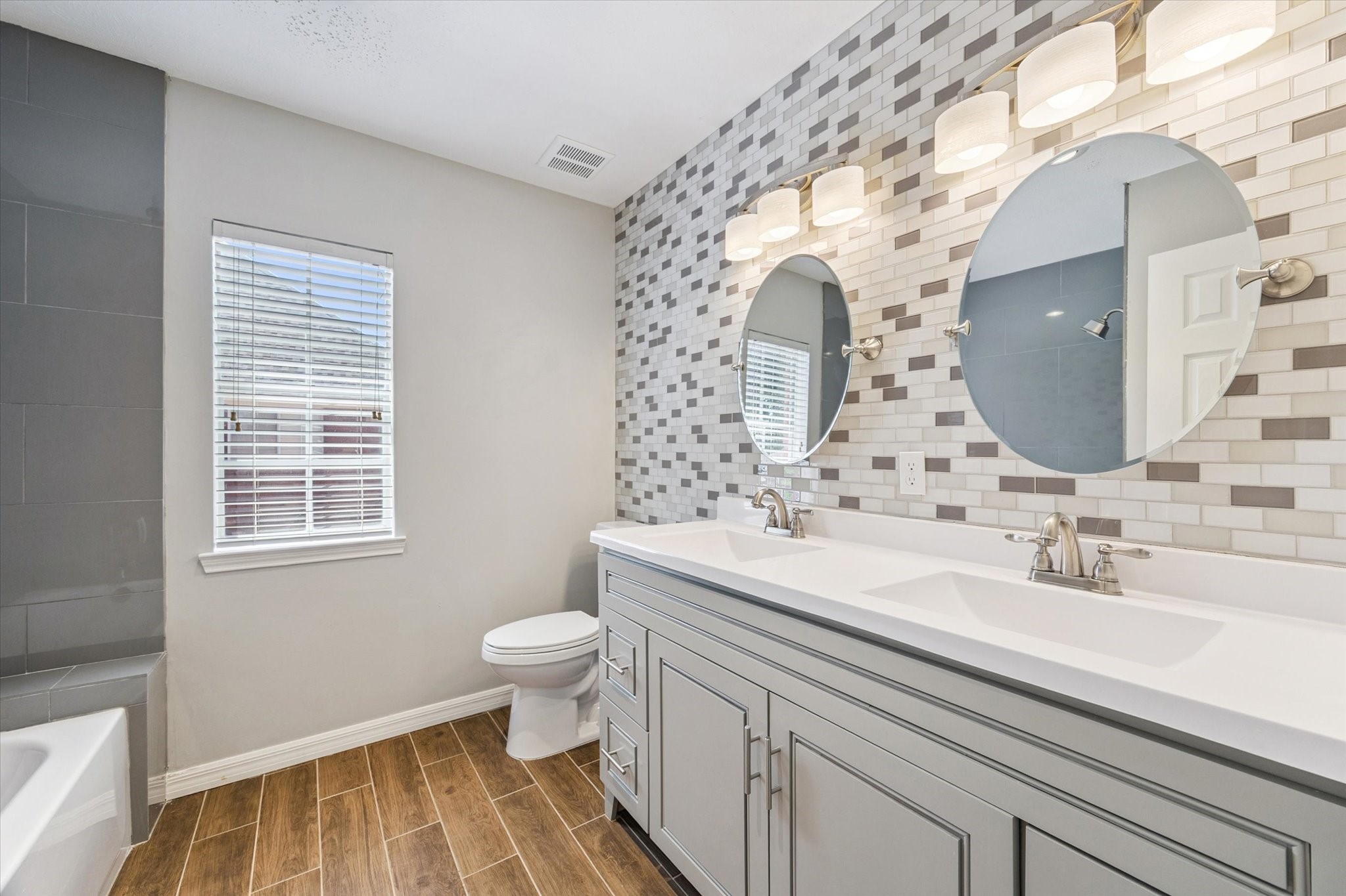 2006 Raven's Crest Drive Sugar Land, TX 77478 - Photo 24 of 29 a bathroom with a sink a toilet and a mirror