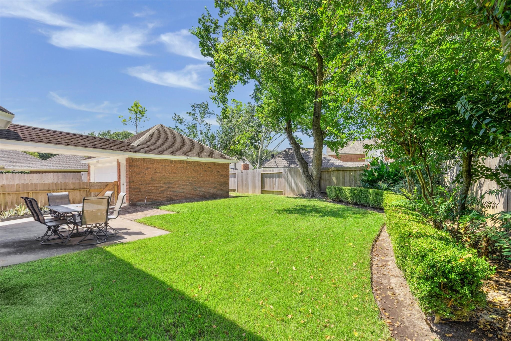 2006 Raven's Crest Drive Sugar Land, TX 77478 - Photo 26 of 29 a view of a backyard with table and chairs and a fire pit