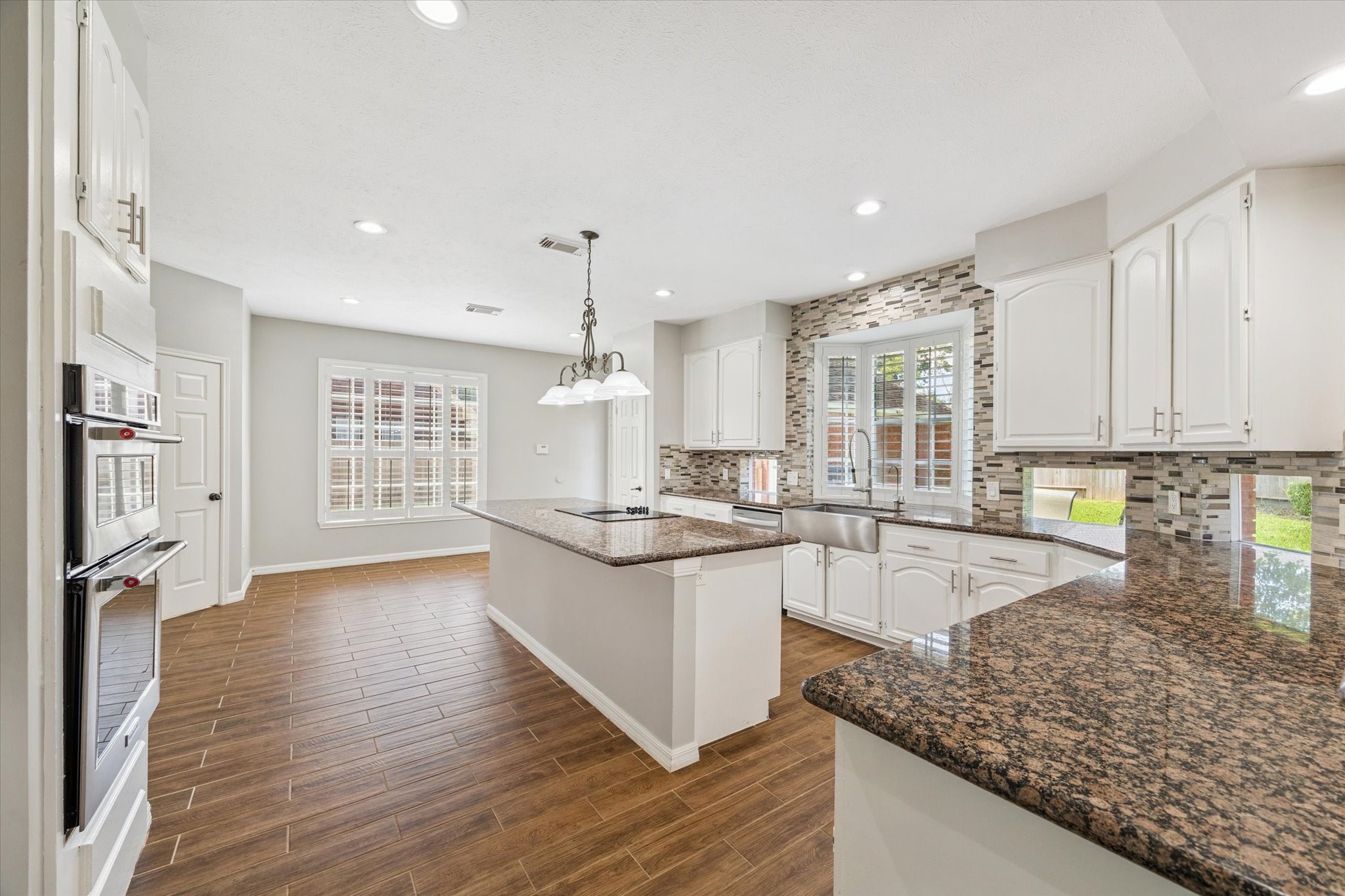 2006 Raven's Crest Drive Sugar Land, TX 77478 - Photo 8 of 29 a large kitchen with stainless steel appliances granite countertop a lot of counter space and wooden floors